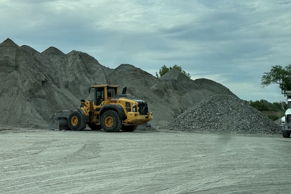Wheel loader scooping processed gravel from a stockpile at the yard