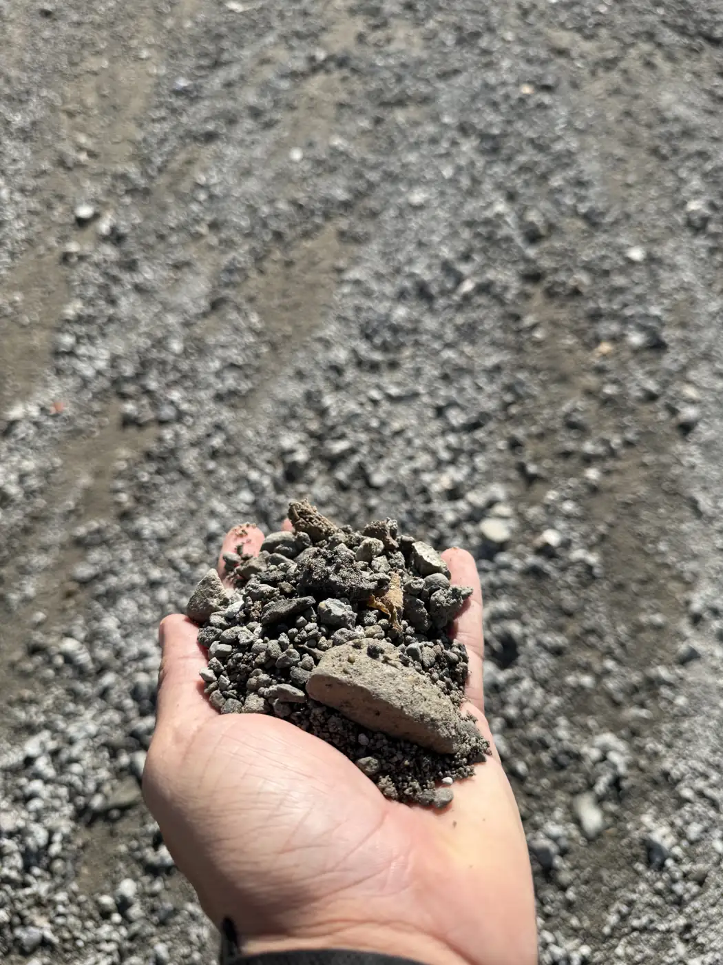 Close-up of 1½" dense grade gravel in a hand