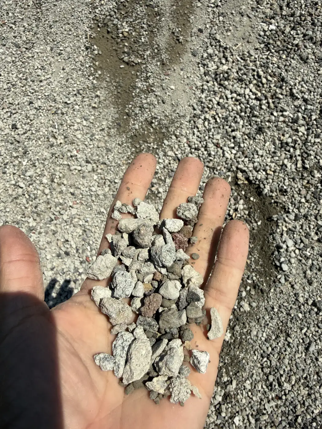 Clean, angular crushed concrete recycled base held in a hand